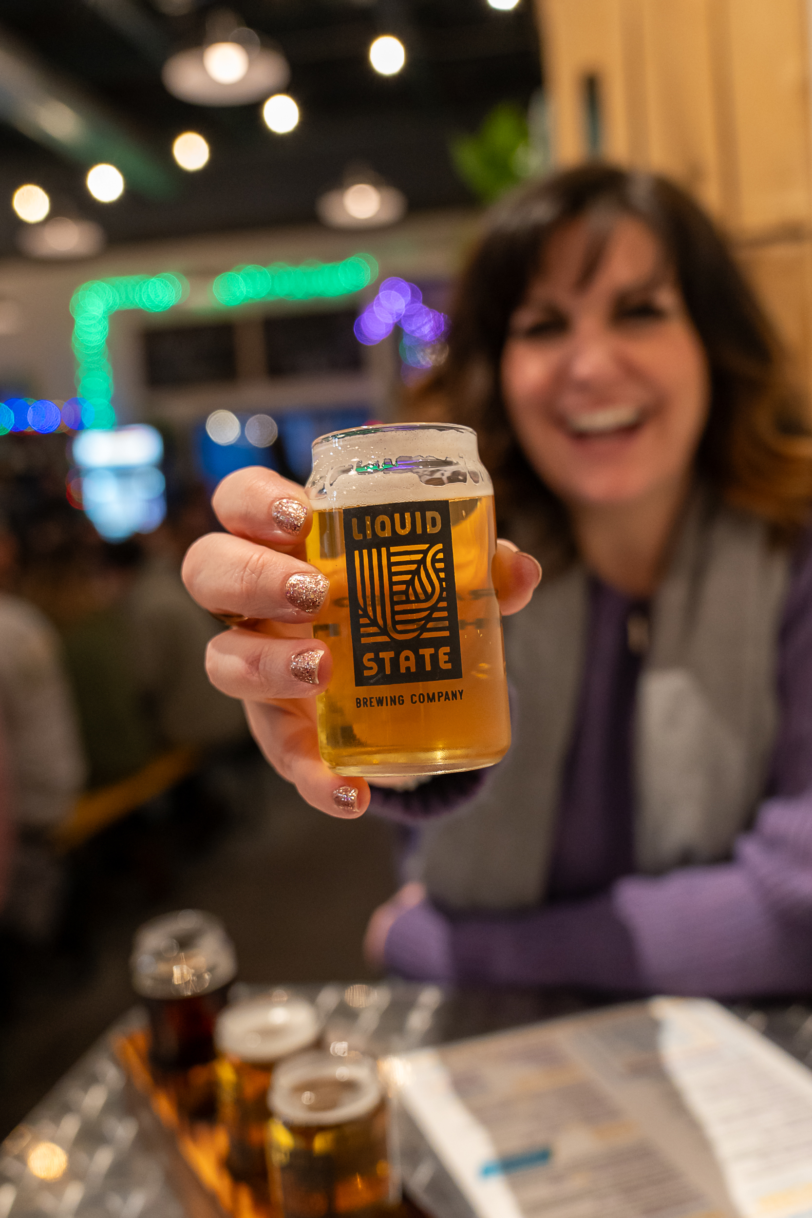 Ithaca Cortland Winter Getaway a woman holding a glass of beer