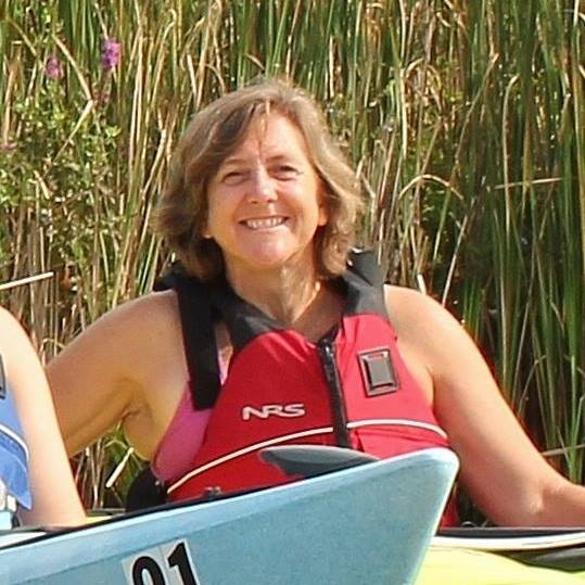 Find Hidden Gems of the Finger Lakes Region - The Long and Short of Paddling a woman in a life jacket
