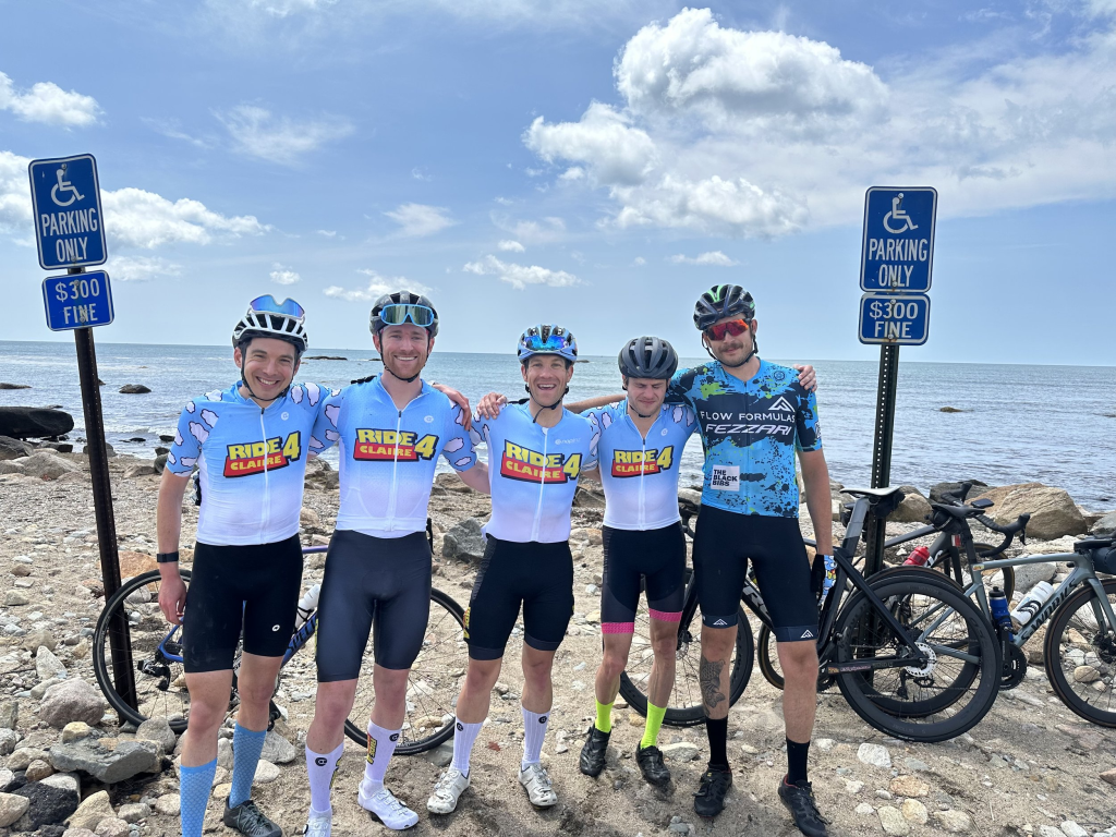 a group of men wearing bicyclists and helmets posing for a photo